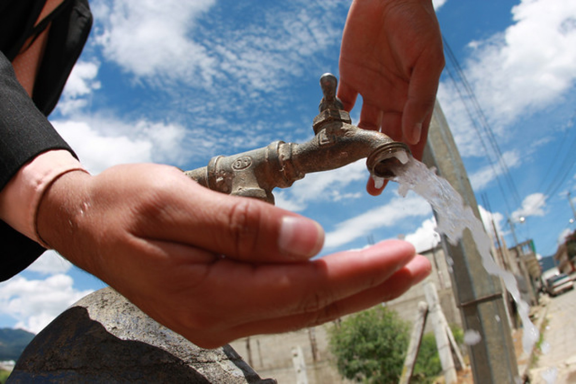 'Drinking water at a street-side water tap' - Athens
