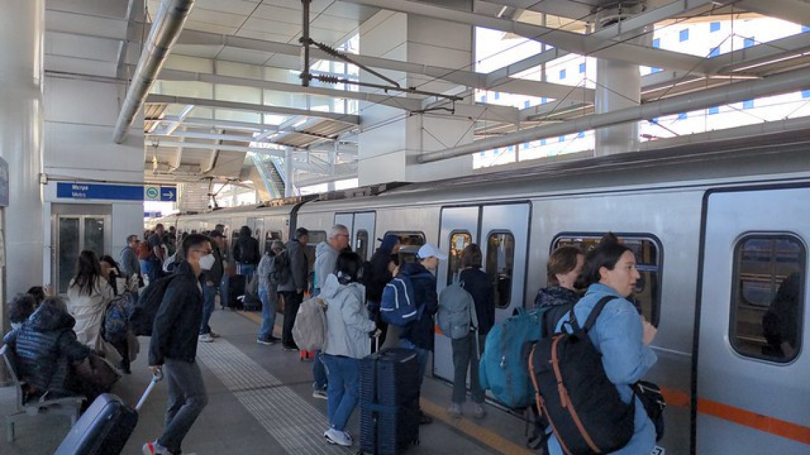 Passengers boarding 11th Batch Athens Metro train at Athens International Airport Station, Greece